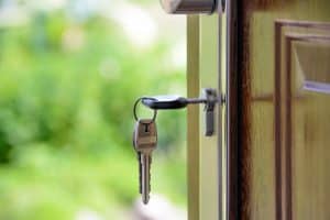 Close up side view of keys hanging from a door lock